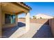 Low-maintenance backyard featuring covered patio, and an enclosure provided by a brick wall at 19202 W Jackson St, Buckeye, AZ 85326