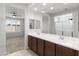 Bright ensuite bathroom featuring double sinks, neutral tiling and view into the bedroom at 19202 W Jackson St, Buckeye, AZ 85326