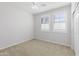 Light-filled bedroom features neutral carpeting, a ceiling fan, and large windows with shutter blinds at 19202 W Jackson St, Buckeye, AZ 85326