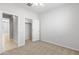 Neutral bedroom featuring carpet, a ceiling fan, and closet with an open doorway at 19202 W Jackson St, Buckeye, AZ 85326