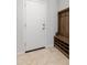 Bright entryway featuring tile floor, coat rack, and a solid white door at 19202 W Jackson St, Buckeye, AZ 85326