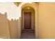 Inviting front entry with an arched doorway and a solid wood door at 19202 W Jackson St, Buckeye, AZ 85326