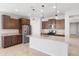 Well-lit kitchen with a center island, stainless steel appliances, and wood cabinets at 19202 W Jackson St, Buckeye, AZ 85326