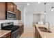 Modern kitchen featuring granite counters, stainless appliances, and a gas range at 19202 W Jackson St, Buckeye, AZ 85326