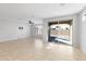 Bright living room with tile floors, a ceiling fan, and sliding glass doors at 19202 W Jackson St, Buckeye, AZ 85326