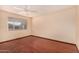 Empty bedroom with hardwood floors, a ceiling fan and a large window at 1925 W Wood Dr, Phoenix, AZ 85029