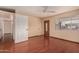 Empty bedroom with hardwood floors, a ceiling fan and a large window at 1925 W Wood Dr, Phoenix, AZ 85029