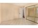 Bedroom features tiled flooring and mirrored closet at 1925 W Wood Dr, Phoenix, AZ 85029