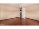 Empty bedroom with hardwood floors, a ceiling fan and a large window at 1925 W Wood Dr, Phoenix, AZ 85029