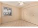 Bedroom features tile floor, closet, and a window providing natural light at 1925 W Wood Dr, Phoenix, AZ 85029