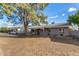 Charming single-story home featuring a carport, covered front porch and mature landscaping at 1925 W Wood Dr, Phoenix, AZ 85029