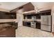 Well-lit kitchen with stainless steel refrigerator and modern appliances at 1925 W Wood Dr, Phoenix, AZ 85029