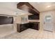 Bright kitchen with dark wood cabinets, modern appliances, and tiled floor at 1925 W Wood Dr, Phoenix, AZ 85029