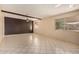 Large living room featuring tile floor, two windows and ceiling fan at 1925 W Wood Dr, Phoenix, AZ 85029