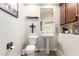 Powder bathroom featuring a pedestal sink, toilet, and decorative elements at 19349 W Oregon Ave, Litchfield Park, AZ 85340