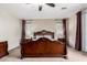 Spacious bedroom with elegant dark wood furniture, ambient lighting, and carpeted flooring at 19349 W Oregon Ave, Litchfield Park, AZ 85340