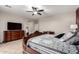 Bedroom features dark wood furniture and a ceiling fan, creating a cozy and inviting atmosphere at 19349 W Oregon Ave, Litchfield Park, AZ 85340