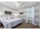 Inviting bedroom featuring a comfortable bed, striped walls, a ceiling fan, and natural light at 19349 W Oregon Ave, Litchfield Park, AZ 85340