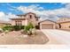 Charming two-story home featuring stone accents, desert landscaping, and a spacious two car driveway at 19349 W Oregon Ave, Litchfield Park, AZ 85340