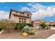 Charming home featuring rock facade, a two-car garage, and lush, mature landscaping at 19349 W Oregon Ave, Litchfield Park, AZ 85340