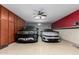 Spacious three car garage featuring a ceiling fan and ample storage cabinets at 19349 W Oregon Ave, Litchfield Park, AZ 85340