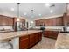 Kitchen featuring an island with tile countertop and wooden cabinets, stainless steel refrigerator at 19349 W Oregon Ave, Litchfield Park, AZ 85340