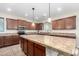 Bright kitchen with tile countertops, stainless steel appliances, and a large island at 19349 W Oregon Ave, Litchfield Park, AZ 85340