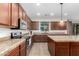 Charming kitchen featuring wood cabinets, stainless steel appliances, and tile flooring at 19349 W Oregon Ave, Litchfield Park, AZ 85340