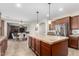 Spacious kitchen island with pendant lighting and stainless steel refrigerator at 19349 W Oregon Ave, Litchfield Park, AZ 85340