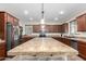 Kitchen featuring an island with tile countertop and wooden cabinets, stainless steel refrigerator at 19349 W Oregon Ave, Litchfield Park, AZ 85340