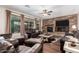 Beautiful living room with a stone fireplace, wood floors, and natural light at 19349 W Oregon Ave, Litchfield Park, AZ 85340