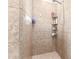 Tiled shower showcasing wall shelving, shower head, and well-maintained neutral finishes at 19349 W Oregon Ave, Litchfield Park, AZ 85340