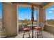 Balcony with chairs and table overlooking distant mountain views and clear blue sky at 19550 N Grayhawk Dr # 2038, Scottsdale, AZ 85255