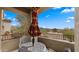 Balcony with table, chairs, and umbrella overlooking mountain views on a sunny day at 19550 N Grayhawk Dr # 2038, Scottsdale, AZ 85255