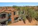 A lovely terracotta-colored home featuring a second story balcony and desert landscaping at 19550 N Grayhawk Dr # 2038, Scottsdale, AZ 85255