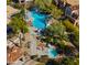 Overhead view of the pool area, equipped with a spa, tables, and chairs, surrounded by lush vegetation at 19550 N Grayhawk Dr # 2038, Scottsdale, AZ 85255