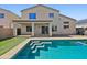 Backyard pool with artificial turf, patio, and view of the two-story home at 19603 N Toya St, Maricopa, AZ 85138