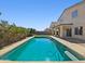 Backyard pool with patio, tall privacy fence, and view of the two-story home at 19603 N Toya St, Maricopa, AZ 85138