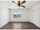 Bright empty room with hardwood floors, a ceiling fan, a bright window view, and white walls at 19603 N Toya St, Maricopa, AZ 85138