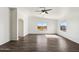 Bright living room with wood-look floors, large windows and an arched doorway at 19603 N Toya St, Maricopa, AZ 85138