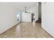 Bright living room with tile floors, a vaulted ceiling, and an open floorplan at 19603 N Toya St, Maricopa, AZ 85138