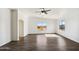 Bright living room with wood-look floors, large windows and an arched doorway at 19603 N Toya St, Maricopa, AZ 85138