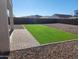 This back yard showcases a patio and artificial turf area, perfect for outdoor relaxation and entertainment at 19889 W Annika Dr, Litchfield Park, AZ 85340