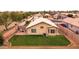 Aerial view of backyard with green lawn, brick patio, and mature trees at 1993 S Spartan St, Gilbert, AZ 85233