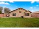 Lush green backyard featuring a covered patio, perfect for outdoor entertaining at 1993 S Spartan St, Gilbert, AZ 85233