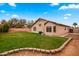 Expansive backyard with healthy lawn and patio, ideal for relaxation and play at 1993 S Spartan St, Gilbert, AZ 85233