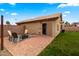 Brick patio with modern seating, string lights, and a view of the lush backyard at 1993 S Spartan St, Gilbert, AZ 85233