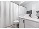 Modern bathroom featuring a shower with white curtain and a white vanity with a marble countertop at 1993 S Spartan St, Gilbert, AZ 85233