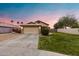 Charming single Gathering home features a well-manicured lawn and two-car garage under a beautiful dusk sky at 1993 S Spartan St, Gilbert, AZ 85233