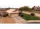 Aerial view of a well-maintained home with a spacious driveway and green front yard at 1993 S Spartan St, Gilbert, AZ 85233